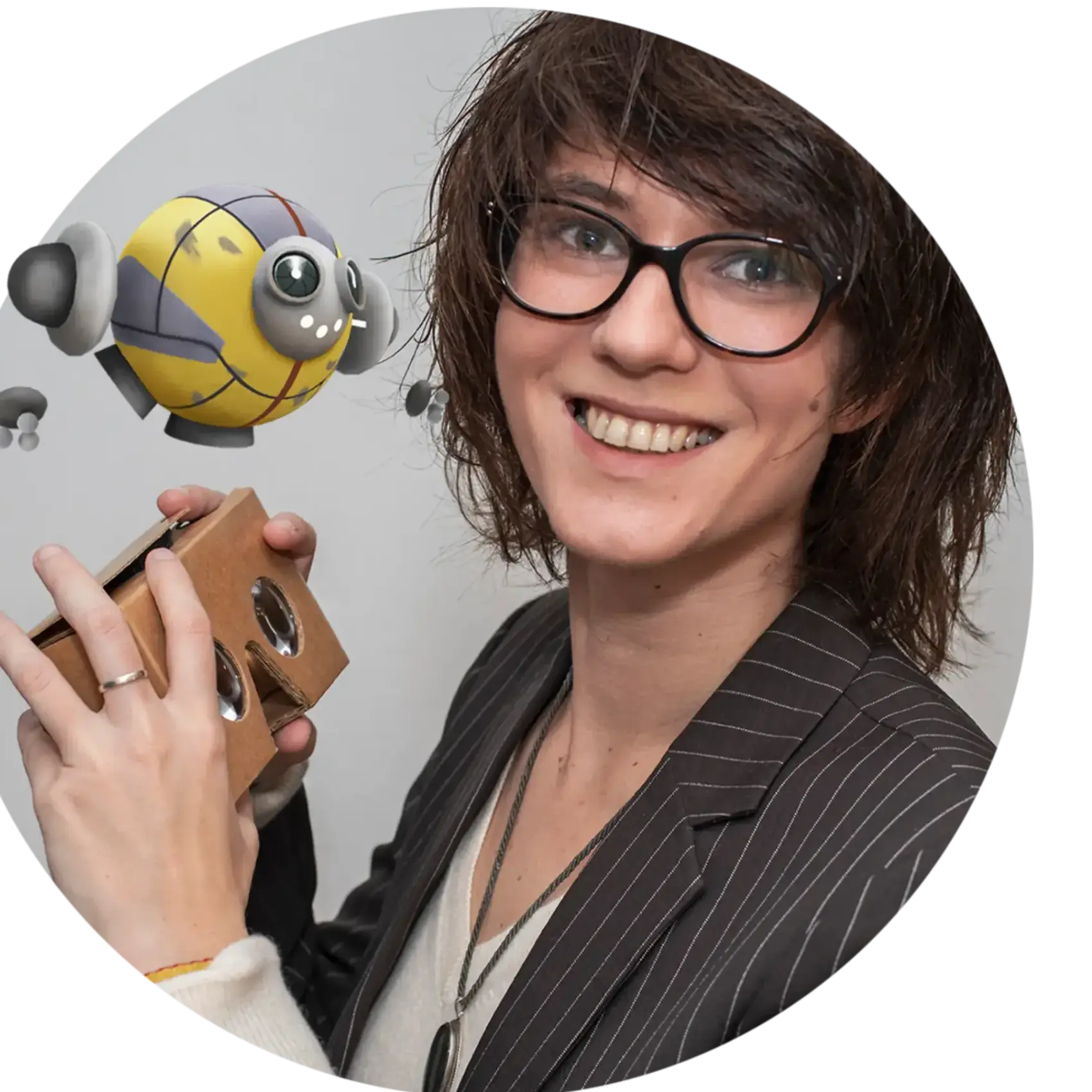 Andy Fidel holding VR cardboard and smiling, pioneer in spatial networks and Woman of the Future.